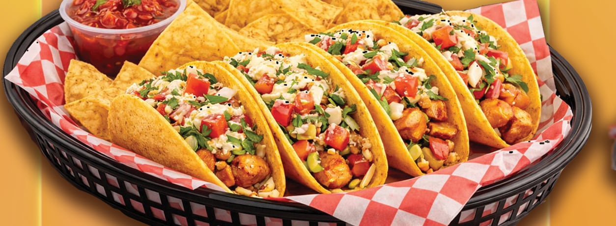 Basket of tacos with chips and salsa
